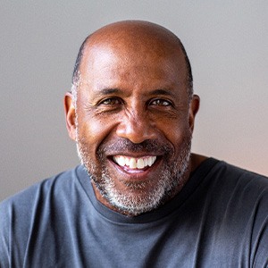 Senior man smiling in gray shirt