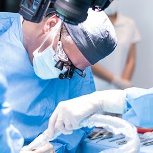 A male dentist performing a dental implant surgery